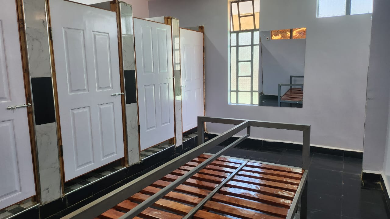 Changing cubicles and a slatted bench in the changing room.