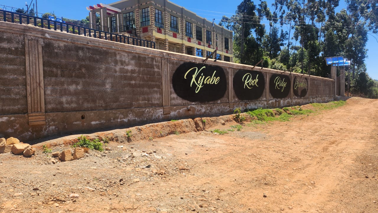 The Kijabe Rock Ridge Gardens name lettered along the boundary wall, with the main building above.
